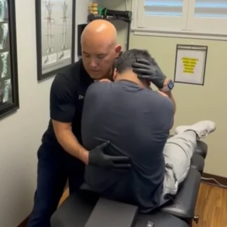Dr. Aranibar adjusting a patient with back pain