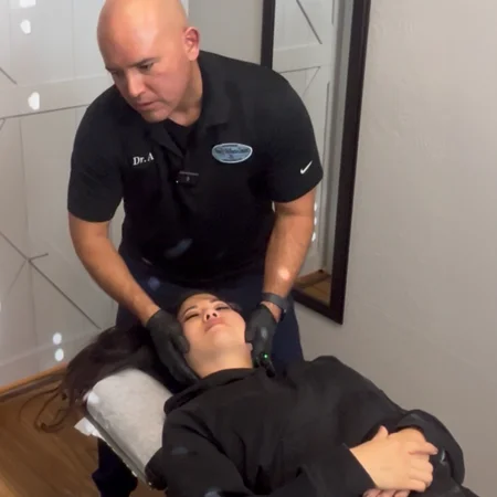 Dr. Aranibar adjusting a patient with neck pain
