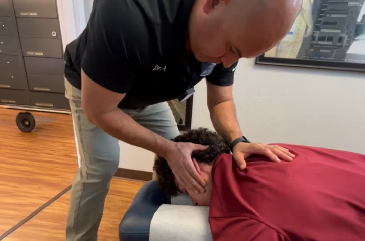Dr. Aranibar adjusting a patient with headaches