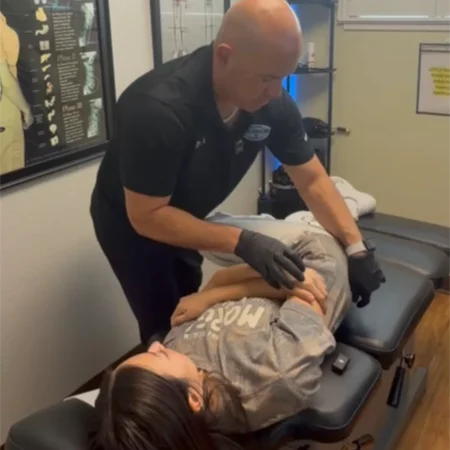 Dr. Aranibar adjusting a patient with sciatica pain